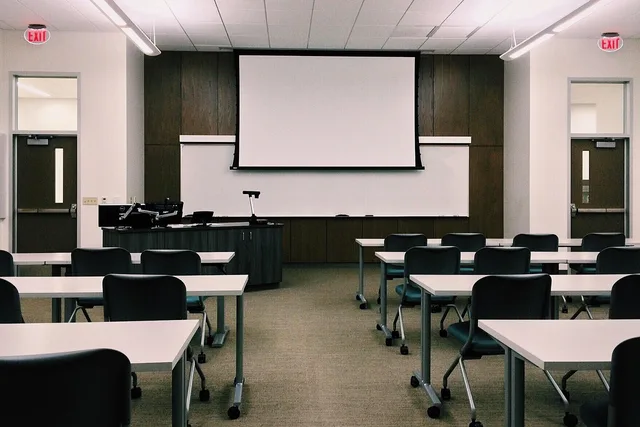 classroom, school, desks, screen, whiteboard, rows, education, university, classroom, classroom, classroom, classroom, classroom, whiteboard, whiteboard, university. Social media training channel strategy: four routes