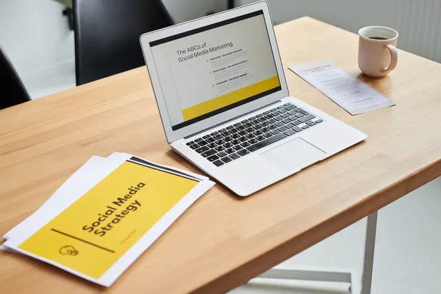 Close-up of a laptop showing a social media marketing strategy in an office setting. Social media training strategy framework: six decisions from work problem to review