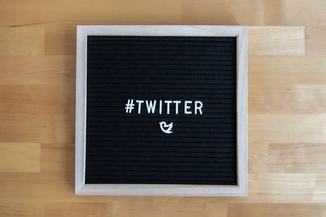 Black letter board with #Twitter hashtag and bird icon, ideal for social media themes. A procurement method for social media training tools and providers